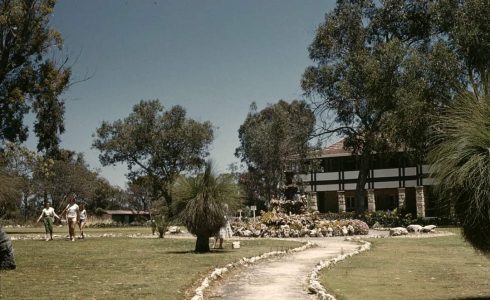 A historic photo of Yanchep land showing visitors walking along a garden path